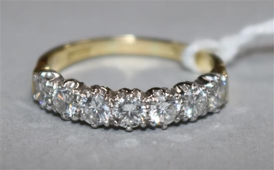 An 18ct gold and seven stone diamond half hoop ring, size R.